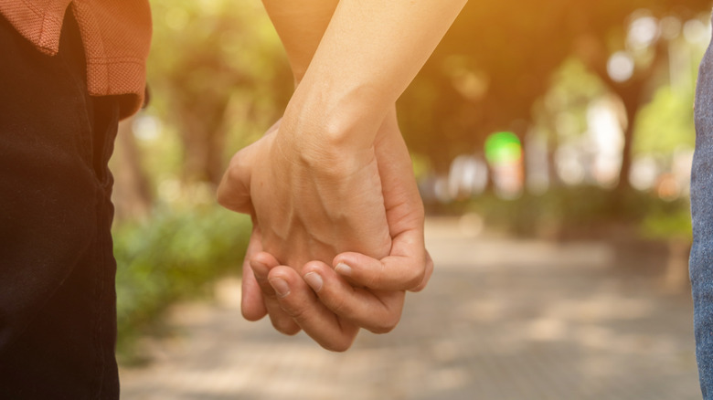 Couple holding hands