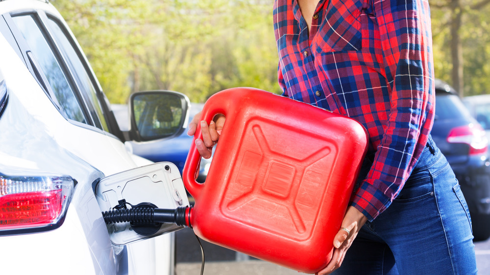 Woman pouring gas