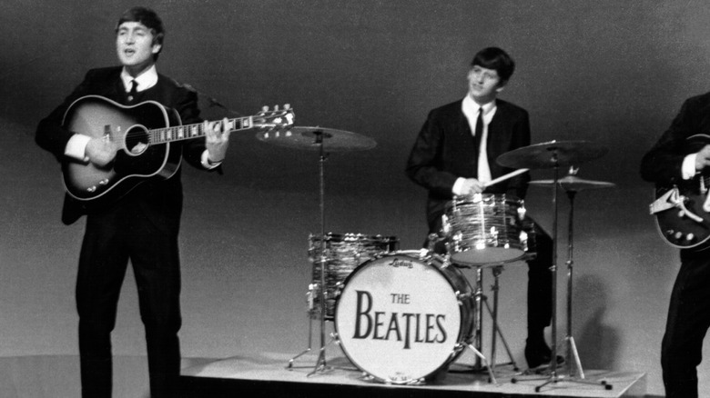 John Lennon and Ringo Starr performing