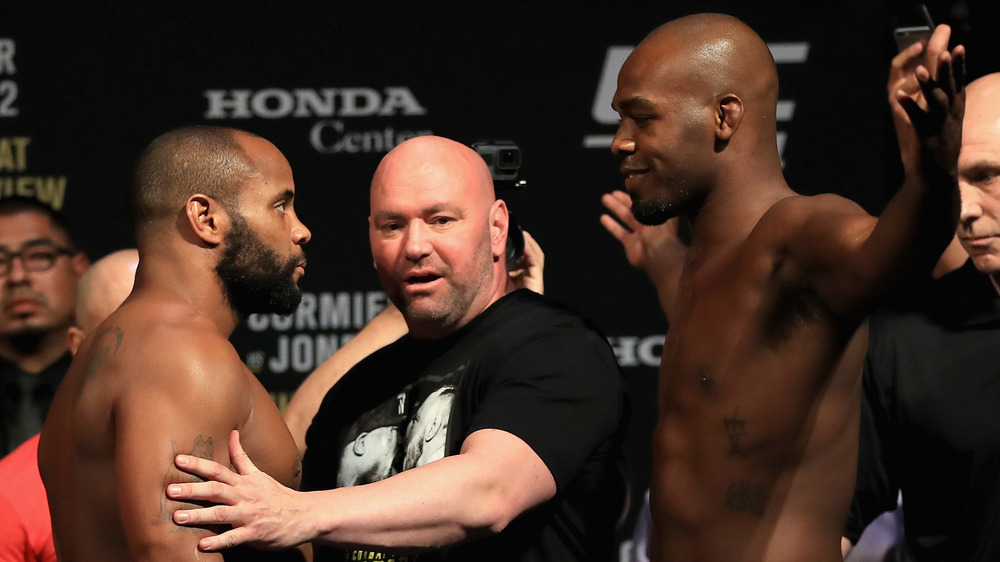 Daniel Cormier and Jon Jones are held back by UFC president Dana White during weigh-ins for UFC 214.