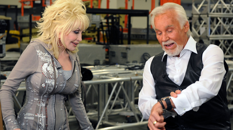 kenny rogers and dolly parton looking at his watch