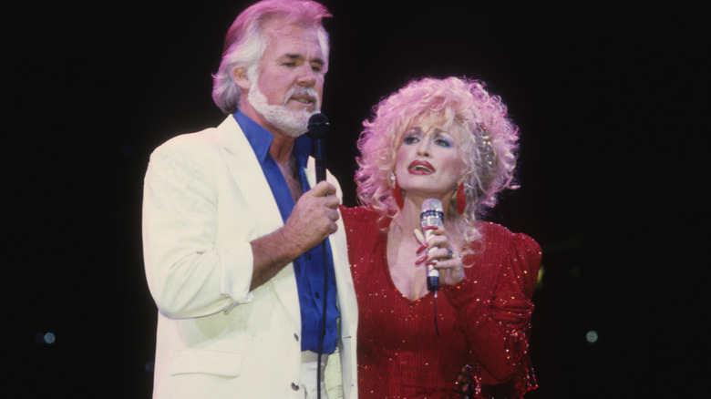 knny rogers and dolly parton performing on stage 1990
