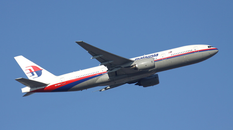 Malaysia Airlines Boeing 777 flying in blue sky