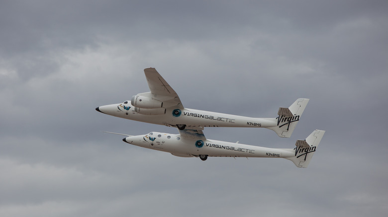 A Virgin Galactic Mothership flies in the air.