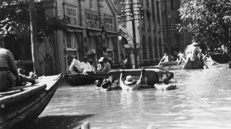 People traversing streets on boats