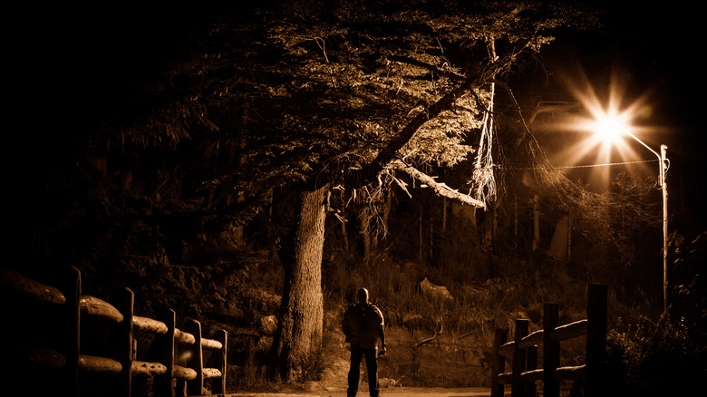 Creepy Man Standing in a Desolate Area at Dark