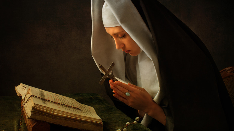 Nun with her Bible praying