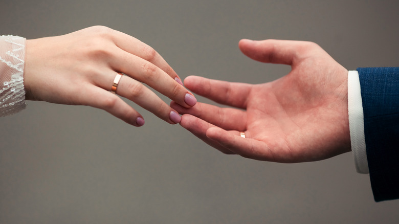 hands touching with wedding rings