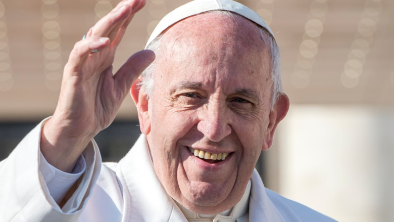 Pope Francis smiles and waves