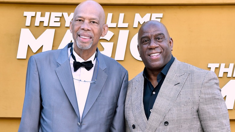 Kareem Abdul-Jabbar and Magic Johnson posing at event