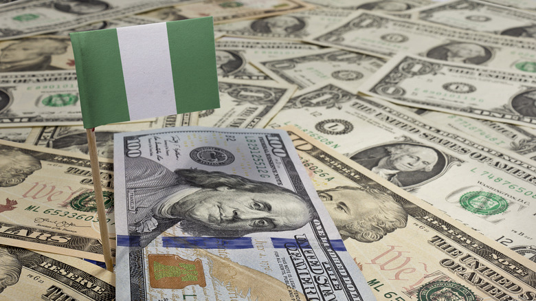 Nigerian flag in pile of dollar bills