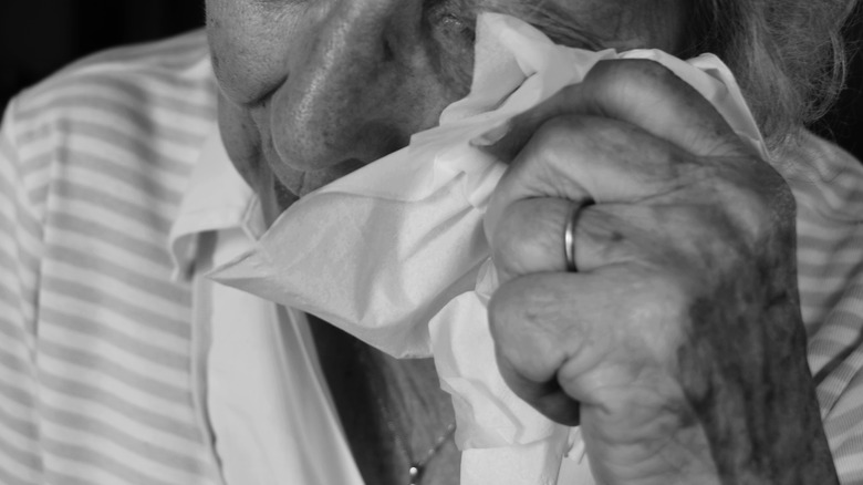 woman crying and holding a tissue