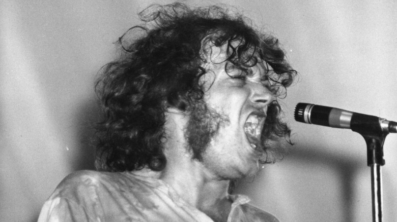 Young Joe Cocker singing into microphone