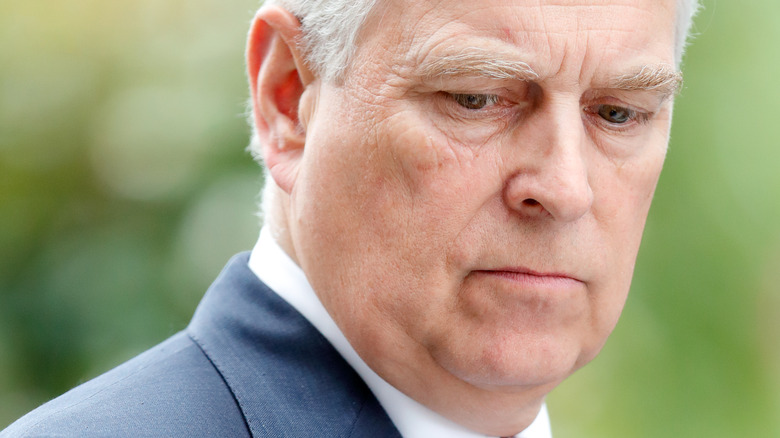Prince Andrew looks down