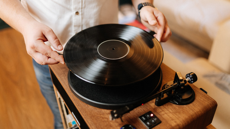 Guy placing vinyl on turntable