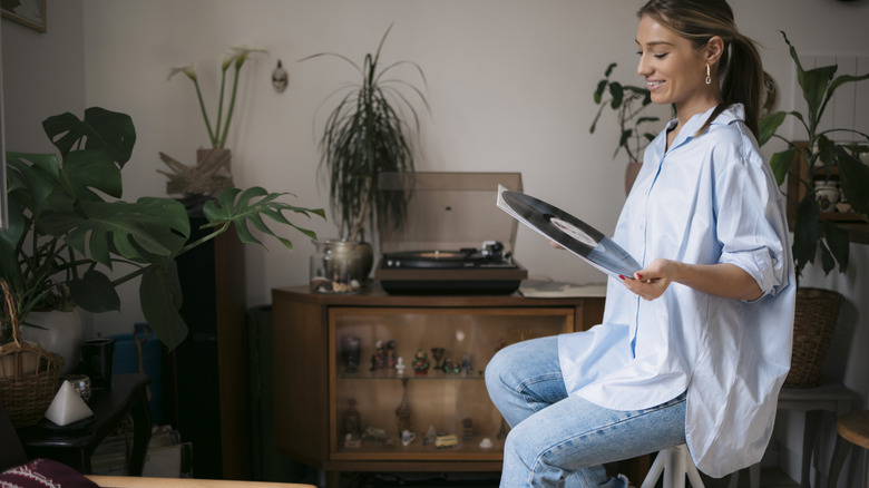 Lady pulling vinyl out of sleeve