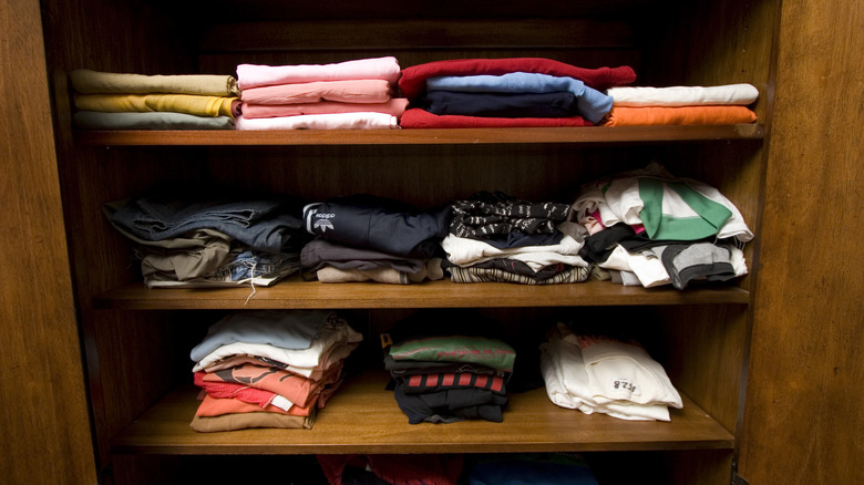 Folded t-shirts on closet shelves