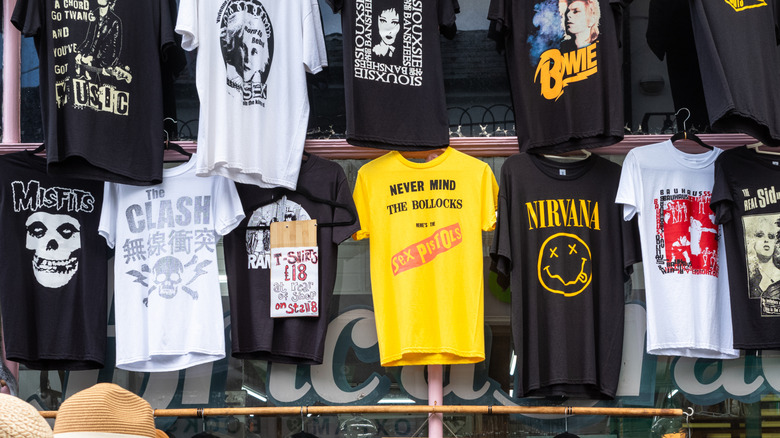 band t-shirts hanging in market stall