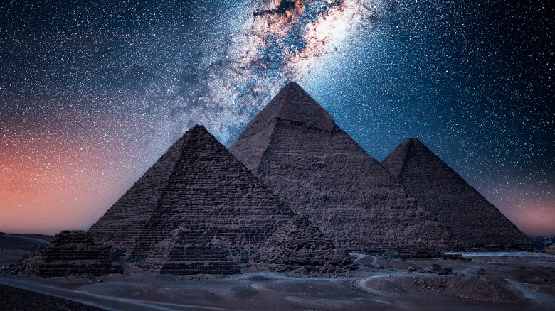 Egyptian pyramids against night sky