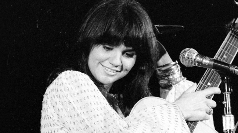 Linda Ronstadt with guitar onstage