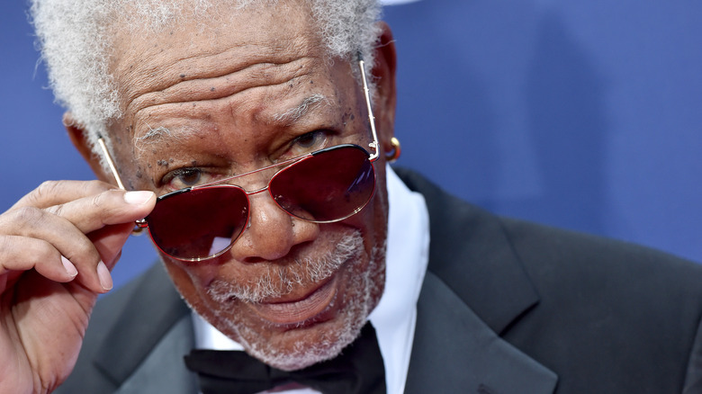 Morgan Freeman looks over sunglasses