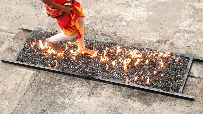 person firewalking on coals