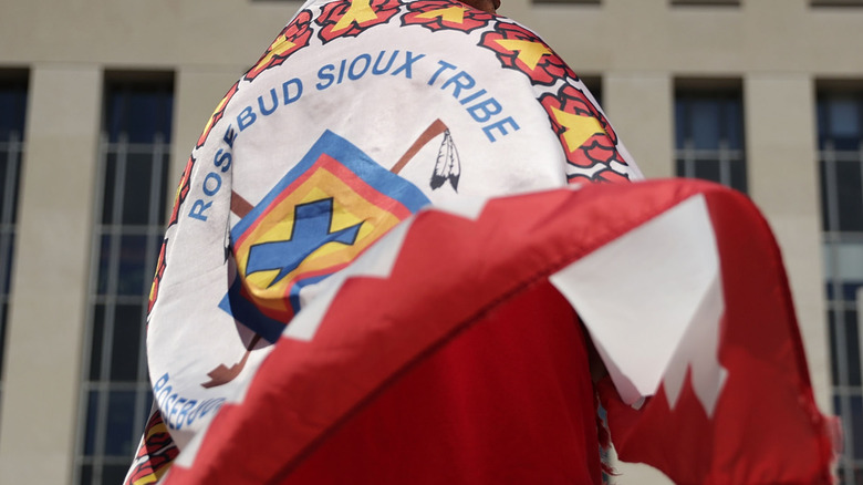 person wearing rosebud sioux flag
