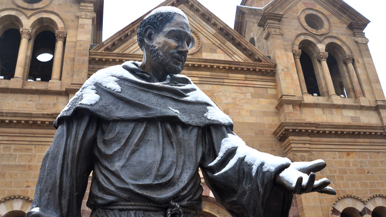 Snow falls on St. Francis statue