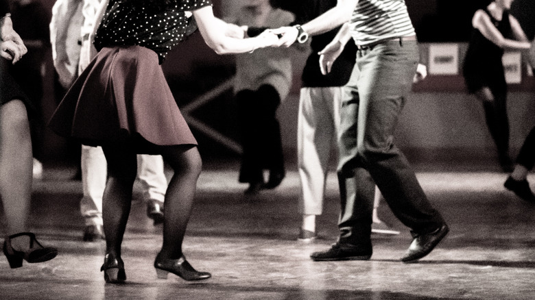 two people swing dancing, image shot from waist down 