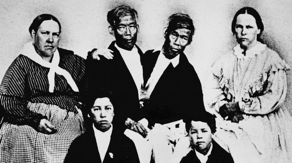 Photograph of Chang and Eng Bunker circa 1865 with wives and sons