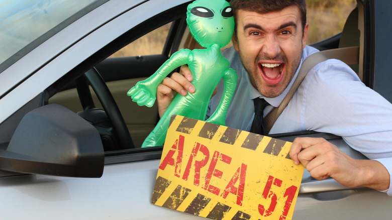 Man holding blow-up alien