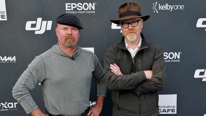 Adam Savage and Jamie Hyneman standing together with hats at event