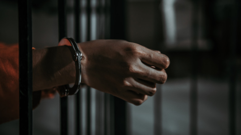 handcuffed wrist in cell