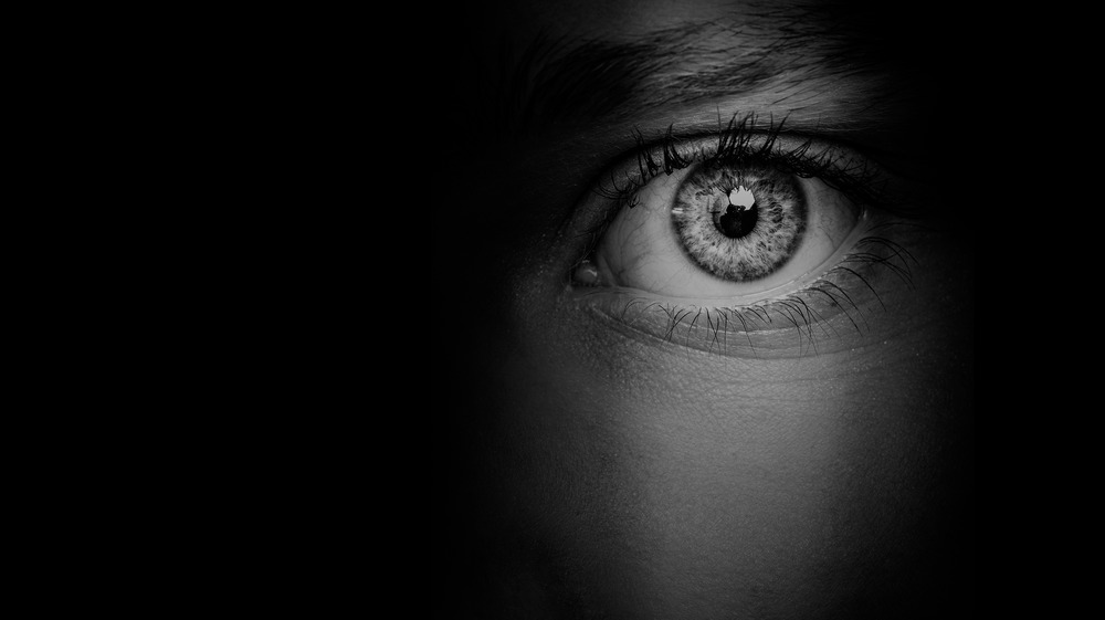 closeup of a woman's eye, covered in shadow