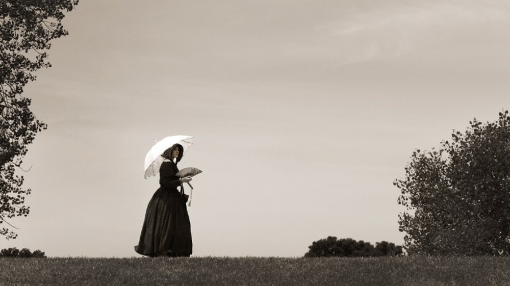 A Civil War era woman walking on a hillside