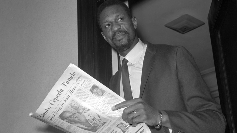 Bill Russell holds newspaper