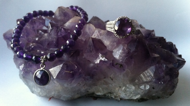 Amethyst jewelry on amethyst geode