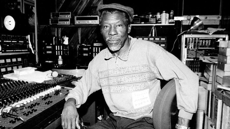 Coxsone DOdd seated at a mixing board