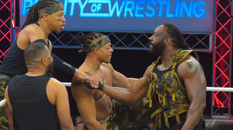 Booker T shaking hands students