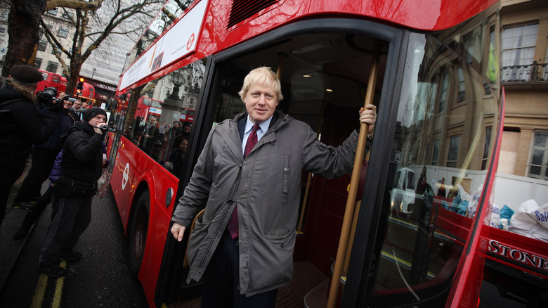 Boris Johnson gets off a bus