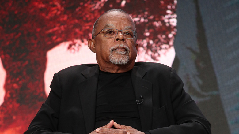 Henry Louis Gates sat dark suit glasses
