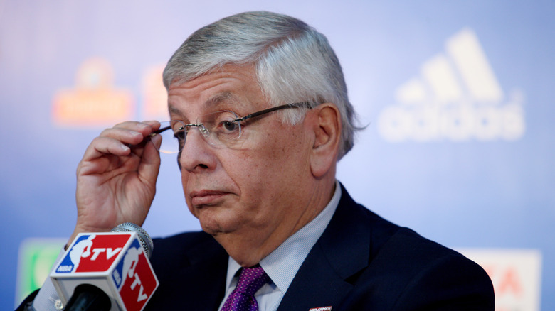 David Stern Wukesong Arena holding glasses NBA mic