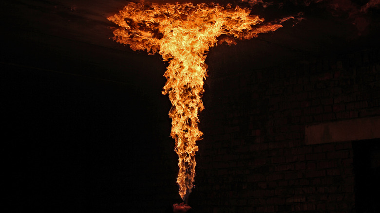 Man breathing fire up