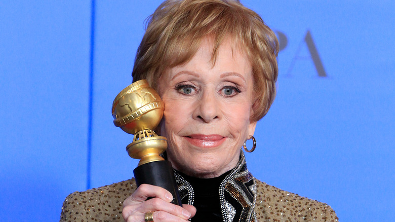 Carol Burnett holding Golden Globe
