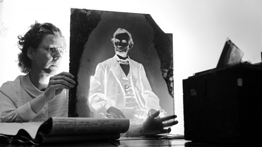 A researcher holding one of America's most priceless negatives, the glass plate made by famous civil war photographer Mathew Brady