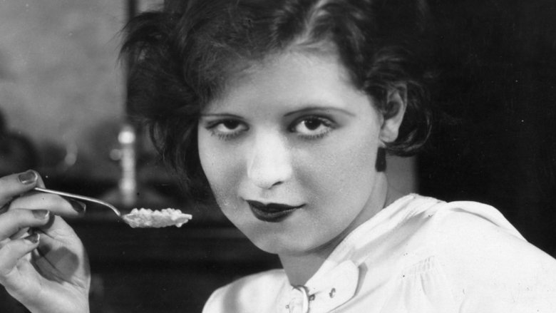 Clara Bow holding a spoon