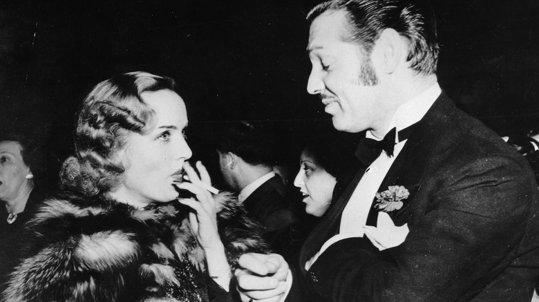 Carole Lombard smoking next to Clark Gable
