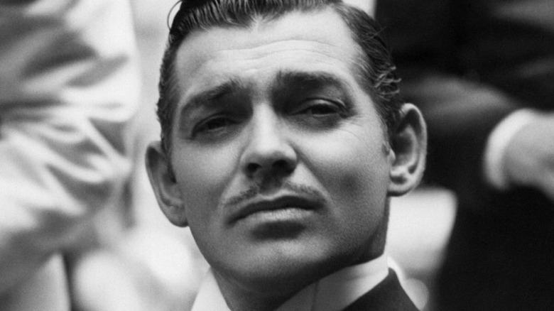 Clark Gable seated and posing
