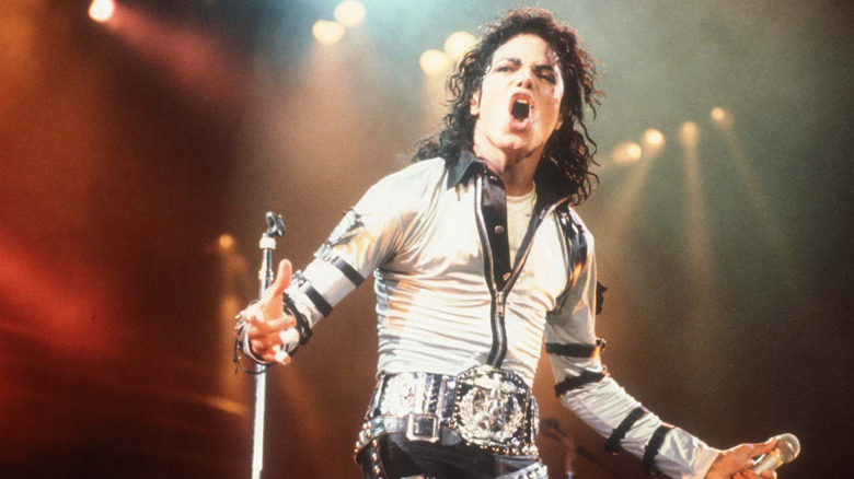 Michael Jackson stood singing in white costume onstage