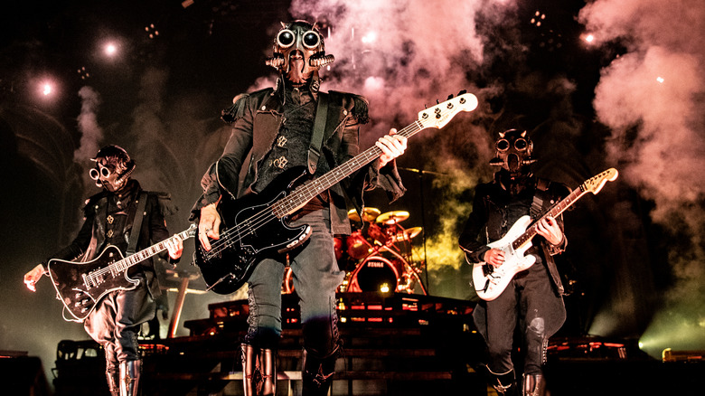 Ghost performing with guitars and masked costumes on stage